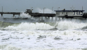 Waves of a stormy sea, crashing against a pier